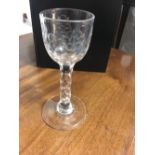 A facet stem wine glass with floral engraved bowl, 5” and a pair of facet stem glasses, 4.5”. (3)