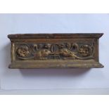 A small antique giltwood frieze, with channelled finger-grip to upper surface, the front decorated