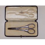A small pair of plain 925 metal grape scissors in Asprey case.