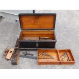 A wooden tool box with carpenter's tools.