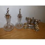 A pair of Birmingham silver mounted oil bottles, a pair of silver mounted glass carver rests and two