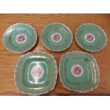 Eight green ground Royal Worcester plates decorated flowers to centre – 'Mona'.