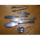 A plain silver seal top caddy spoon, 1902, three butter knives, a pair of tongs and a bookmark. (6)