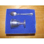 A Sheffield silver egg cup and spoon. (2)