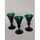 Three 19thC green glass trumpet wines., 5”.