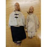 Two small early 20thC Chinese dolls with wooden heads, 11”.