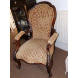 A Victorian walnut upholstered armchair.