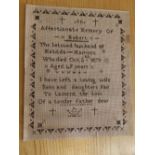 A black thread sampler worked on perforated card ground – 'In affectionate memory of Robert