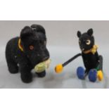 A mechanical wind up 'foreign' made scottie dog, having glass eyes, measuring 11cm long,