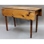 A miniature pine drop leaf table, raised on turned legs,