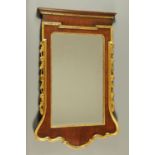 A George II style walnut veneered mirror, 18th century and later,