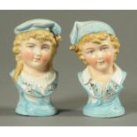 A pair of Edwardian bisque ware busts, boy and girl. Height 13.5 cm.