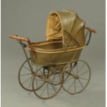 A Victorian child's toy perambulator, with leather upholstery,