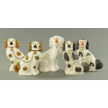 A pair of Staffordshire spaniels, 19th century, each with copper lustre patches,