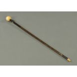 A Victorian walking cane, with ivory ball top and bone foot. Length 85 cm.