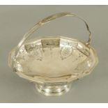 A silver fruit bowl, pierced and with swing handle, by William Suckling Ltd.