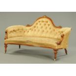 A Victorian inlaid walnut sofa, of shaped outline and with exposed moulded showframe.