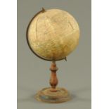 A Geographia 8" terrestrial globe, raised on a turned ebonised stand and with brass circumference.