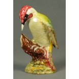 A Beswick woodpecker, mid 20th century, naturalistically modelled on a tree stump with leafy base,
