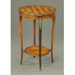 A Victorian walnut and satinwood chess topped table, with metal mounts, cabriole legs and low shelf.