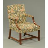 An Edwardian mahogany Gainsborough style armchair, upholstered in foliate patterned material.