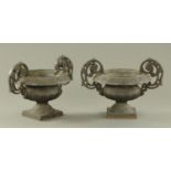 A pair of cast iron low garden urns. Height 30 cm, width 43 cm.