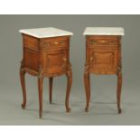 A pair of oak bedside cabinets, Continental, with white and grey variegated marble tops,