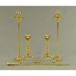 A pair of brass andirons, with lion mask decoration, pair of fire companion stands and poker.