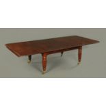 A Regency mahogany dining table, with three leaves, with brass fittings stamped "L.