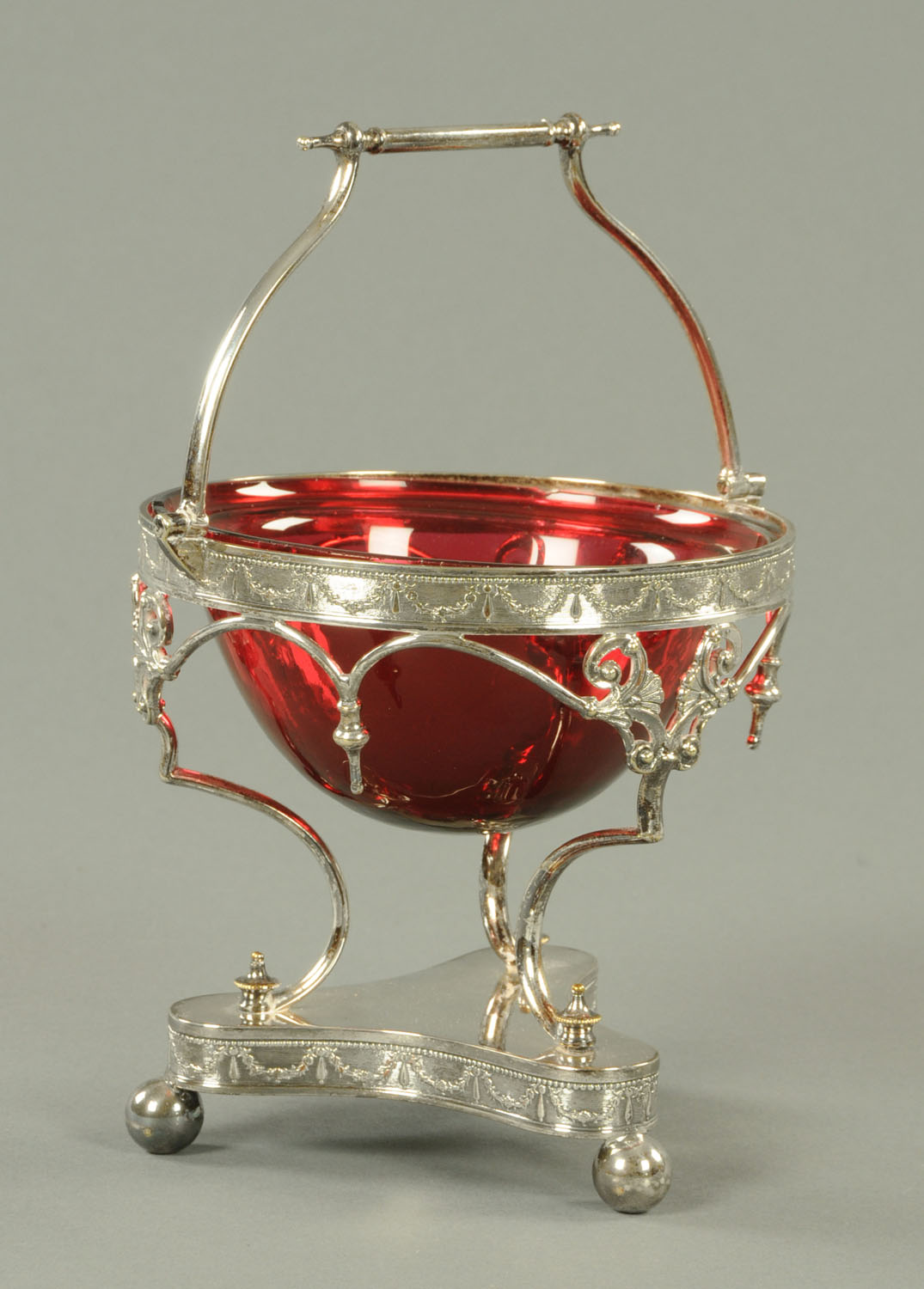 An Edwardian cranberry glass bowl, housed in a plated stand. Height excluding carrying handle 13.