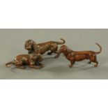 After Franz Bergman, a patinated bronze group of two dachshunds and a single standing dachshund,