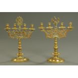 Two similar German brass four branch candelabra, 18th century, one surmounted by a crowned eagle,