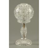 A cut glass table lamp, 20th century, decorated with a series of hobnail and strawberry cut panels.