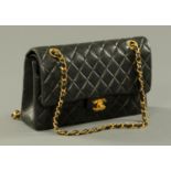 A classical Coco Chanel black quilted lamb 2.55 double flap bag, Serial No.