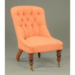 A Victorian ladies chair, with deep buttoned back and stuffover seat,