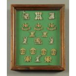 A cased set of crests, probably family crests, 19th century. Case 30 cm x 24 cm.