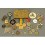 A First World War Christmas tin, containing miscellaneous medals, badges, etc.