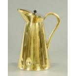 A large brass lidded jug, with black ceramic knop, stamped to underside "29 J.M.