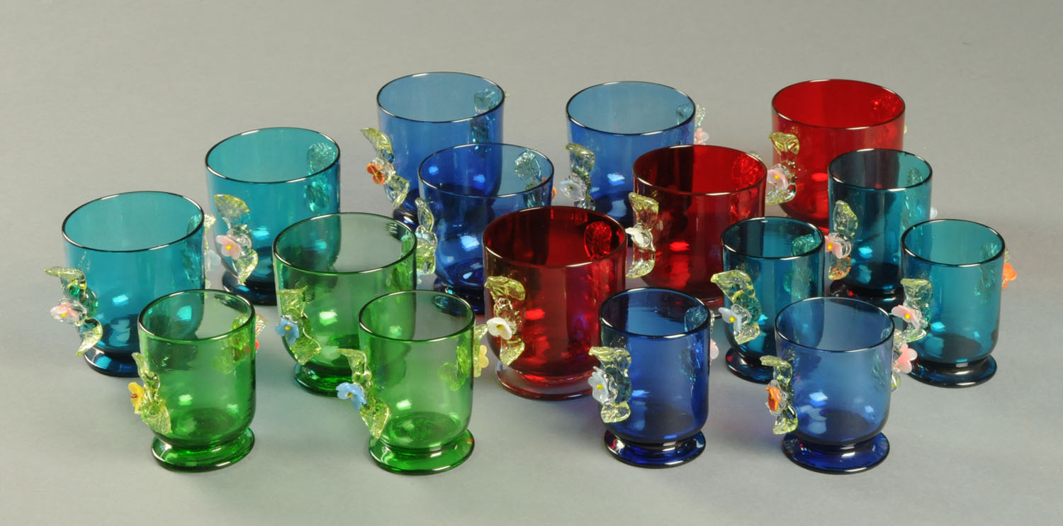 Sixteen Victorian coloured glasses, each with applied foliate decoration.