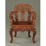 An early 20th century Chinese carved wooden chair, with solid seat and raised on cabriole legs.