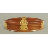 An Indian wooden oval casket, with metal bindings. Length 39 cm.