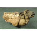 A 19th century carved sandstone winged ram. Length 76 cm, height 40 cm.