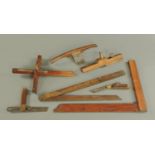 A collection of antique woodworking tools, T-square, spoke shave, etc.