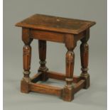 A reproduction oak joint stool, with rectangular top, turned legs and low stretchers. Width 45.