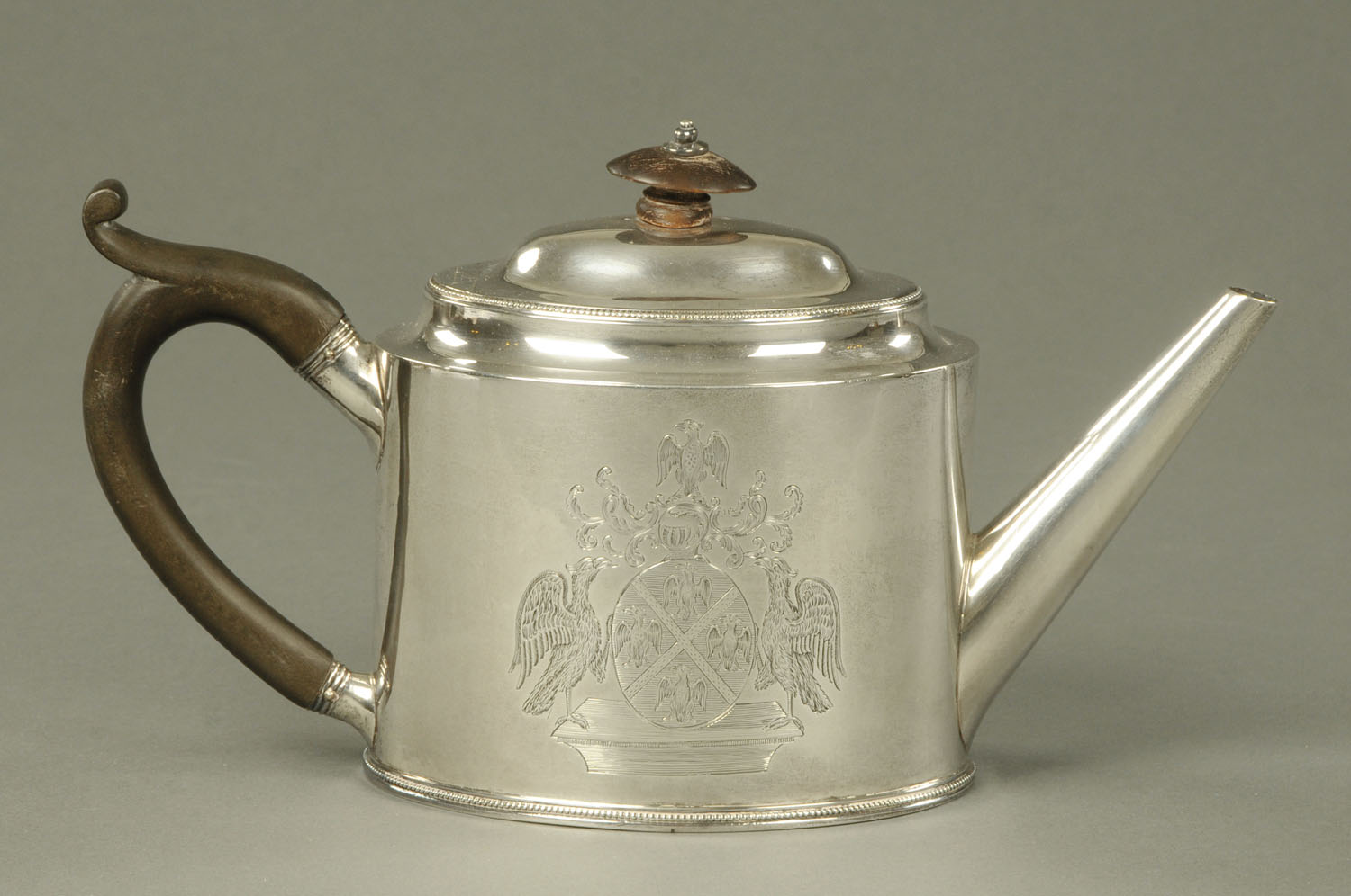 A George III plain oval teapot, London 1788, with griffin armorial, maker Hester Bateman, 453 grams.