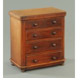 A Victorian miniature chest of drawers,
