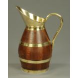 A 19th century brass bound oak jug, large form. Height 54 cm.