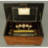 A large late 19th century rosewood and marquetry cased music box, playing six airs,