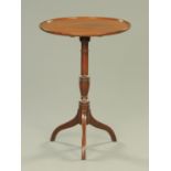 An early 19th century mahogany tripod table, circular, with snap action,