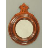 A Regency mahogany framed circular wall mirror, with painted pediment. Diameter 34.